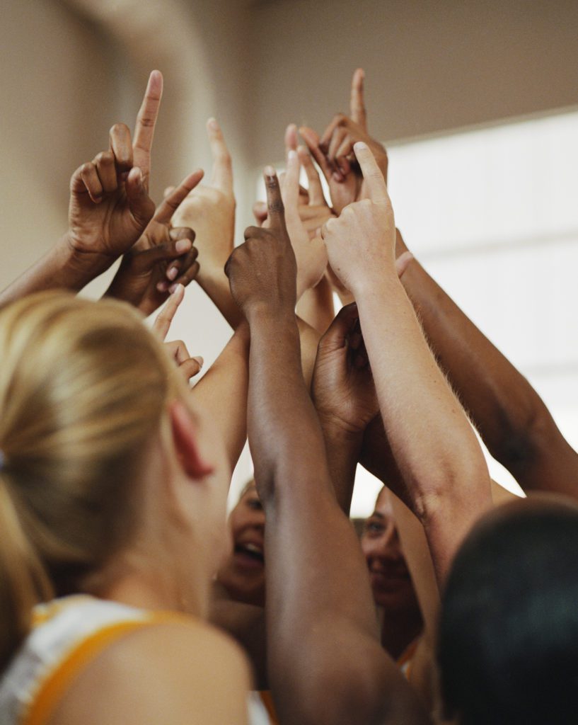 Basketball team hands up together