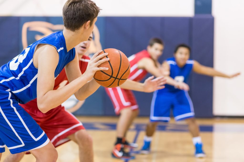 Boys in high school playing basketball